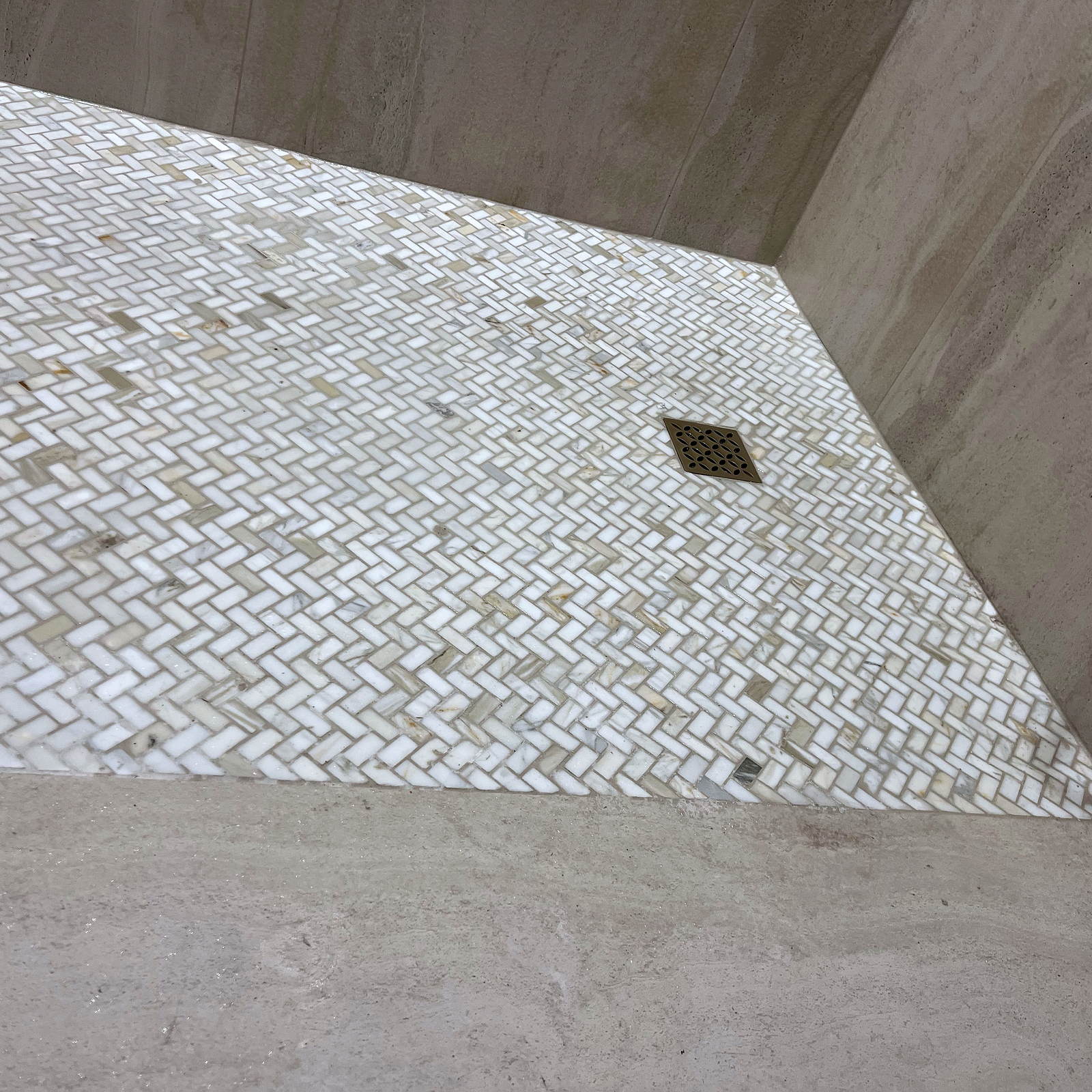 Herringbone mosaic shower floor with square drain