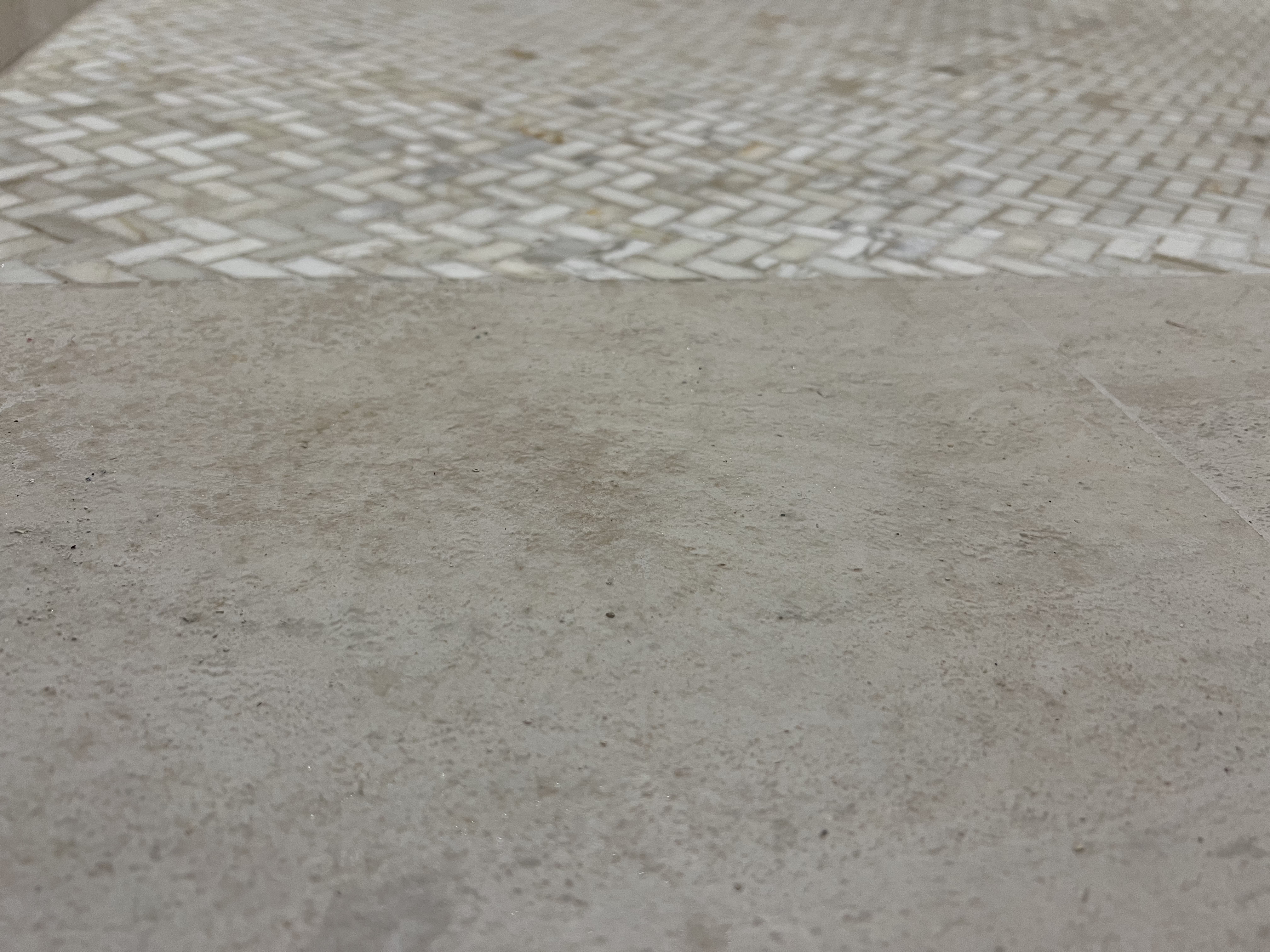 Herringbone tile transition detail in remodeled interior