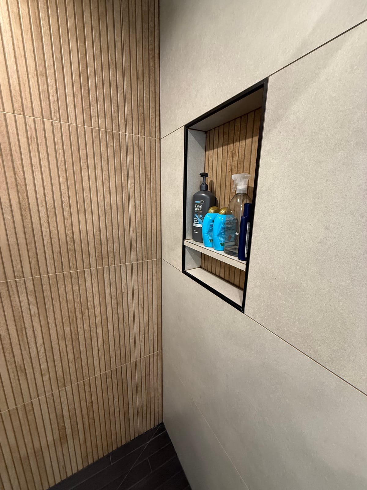Shower niche and wood-slat detail in bathroom remodel