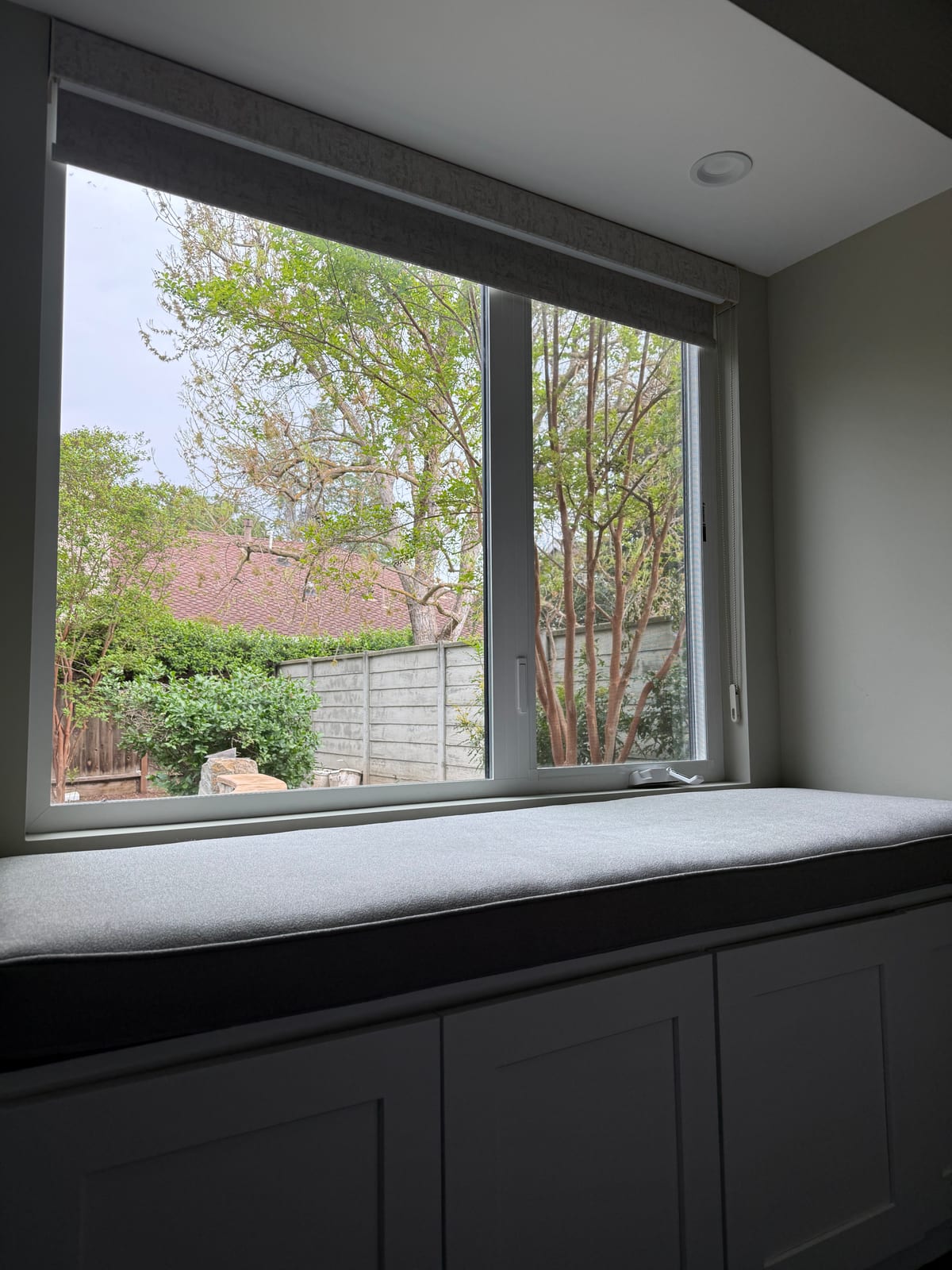 Custom window seat with storage cabinetry