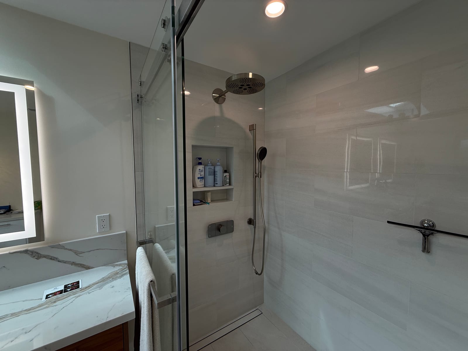 Glass walk-in shower bathroom remodel with marble vanity