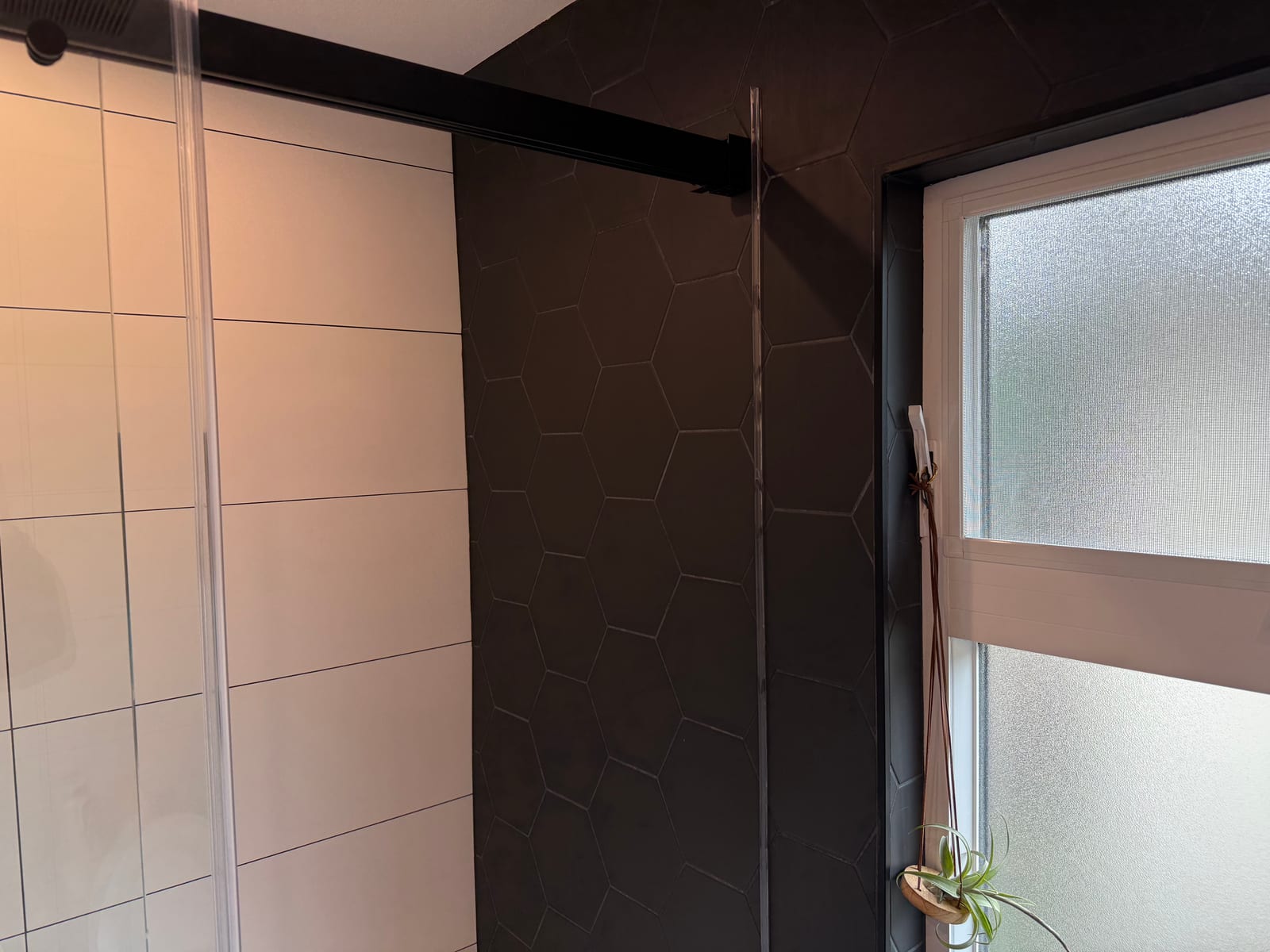 Shower tile detail with hexagon accents and frosted window